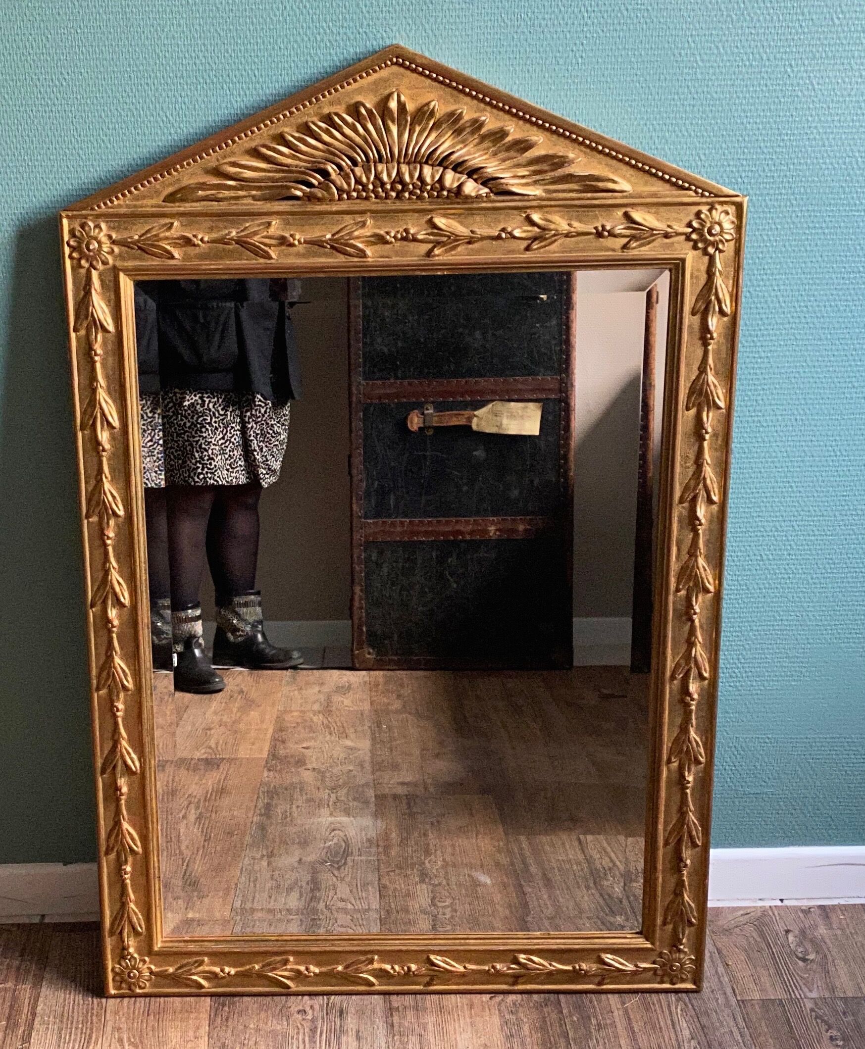 Mirror in gilded wood with a triangle pediment decorated with half sunflowers
