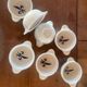 Set of seven earthenware bowls, Quimper, lily flower decoration.