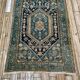 Persian carpet old green background, hand knotted, certified