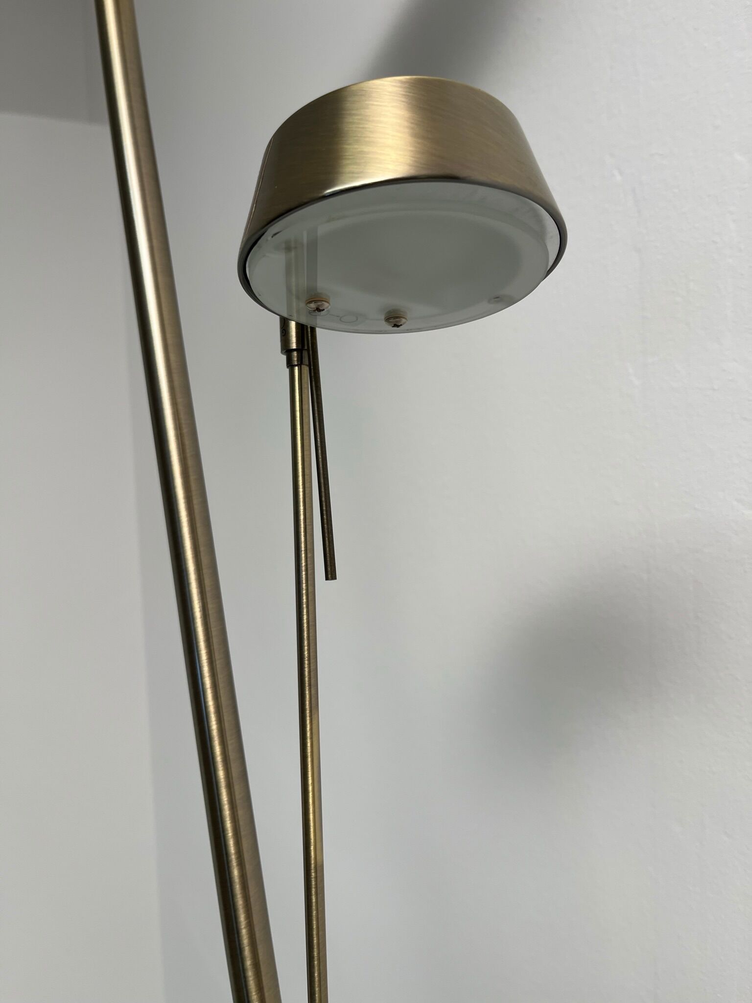 Golden metal floor lamp with reading light