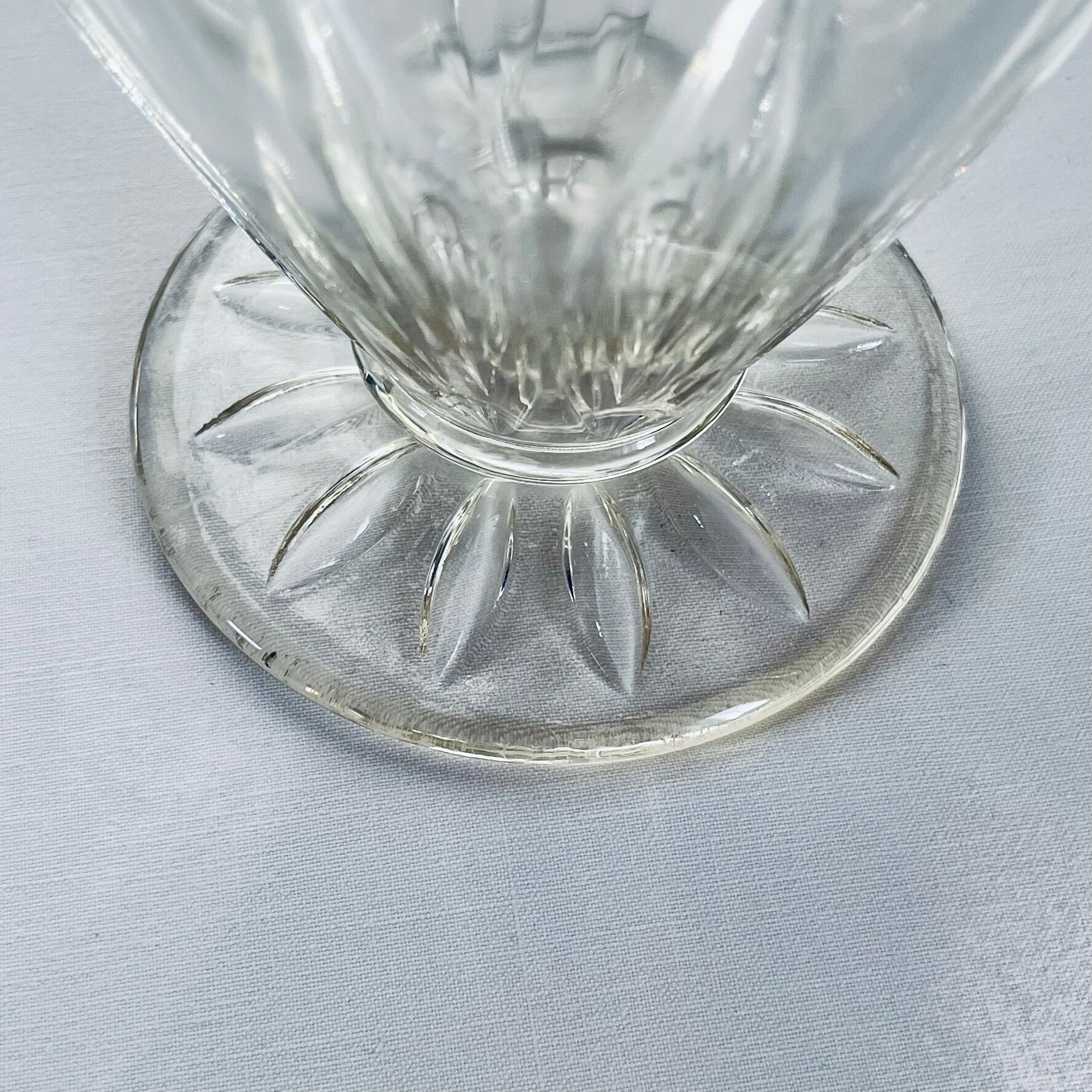 Glass pitcher on base