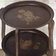 Two old trays on a stand/console.