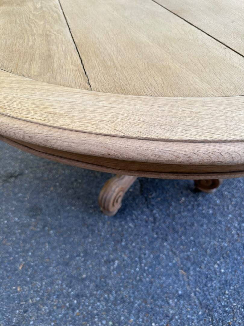 Round dining table with a central pedestal, stripped raw oak, 4 extensions, 19th century.