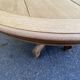 Round dining table with a central pedestal, stripped raw oak, 4 extensions, 19th century.