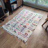 White Moroccan rug with Berber patterns.