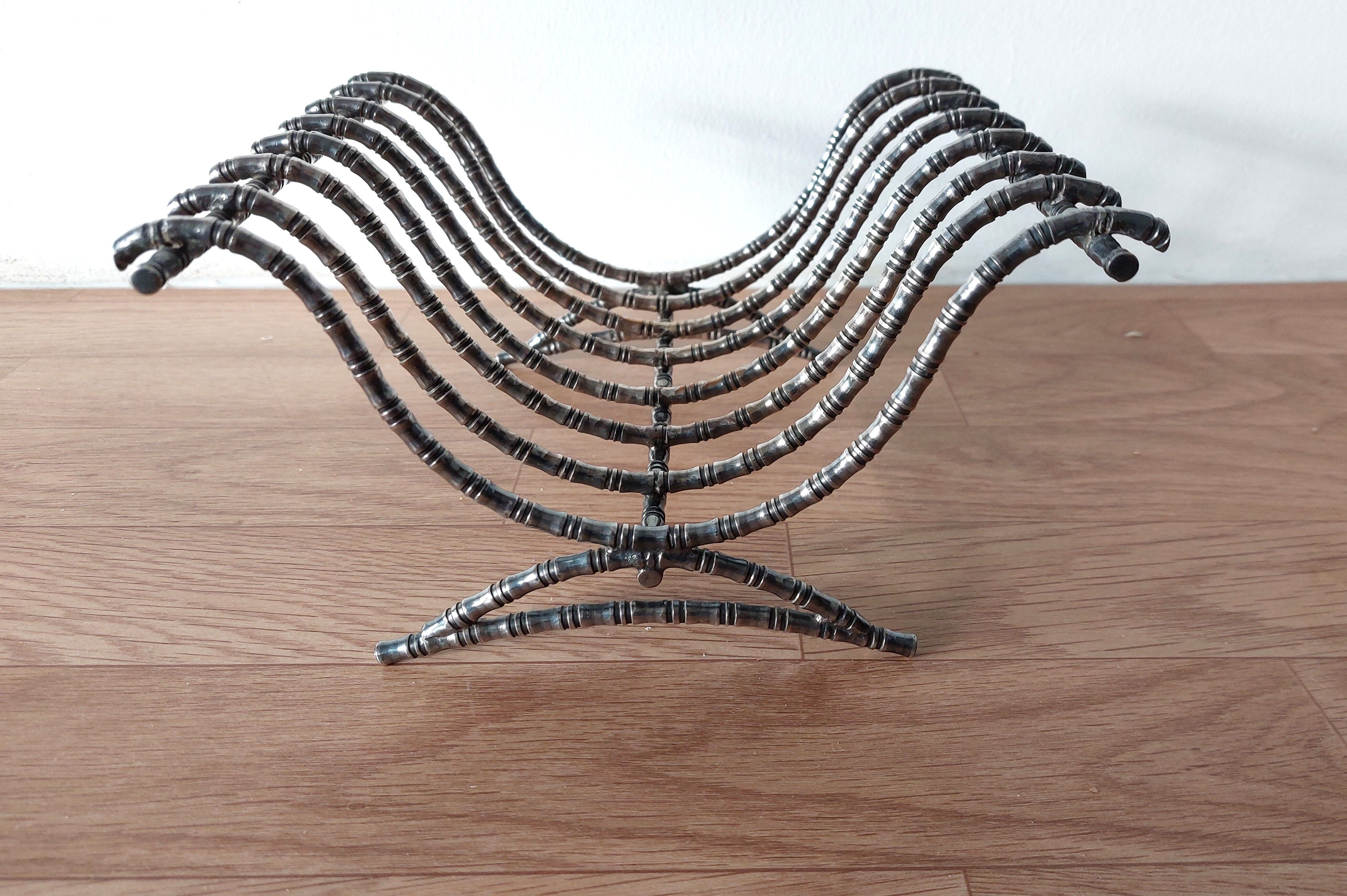 Silver metal cut in imitation of vintage bamboo.