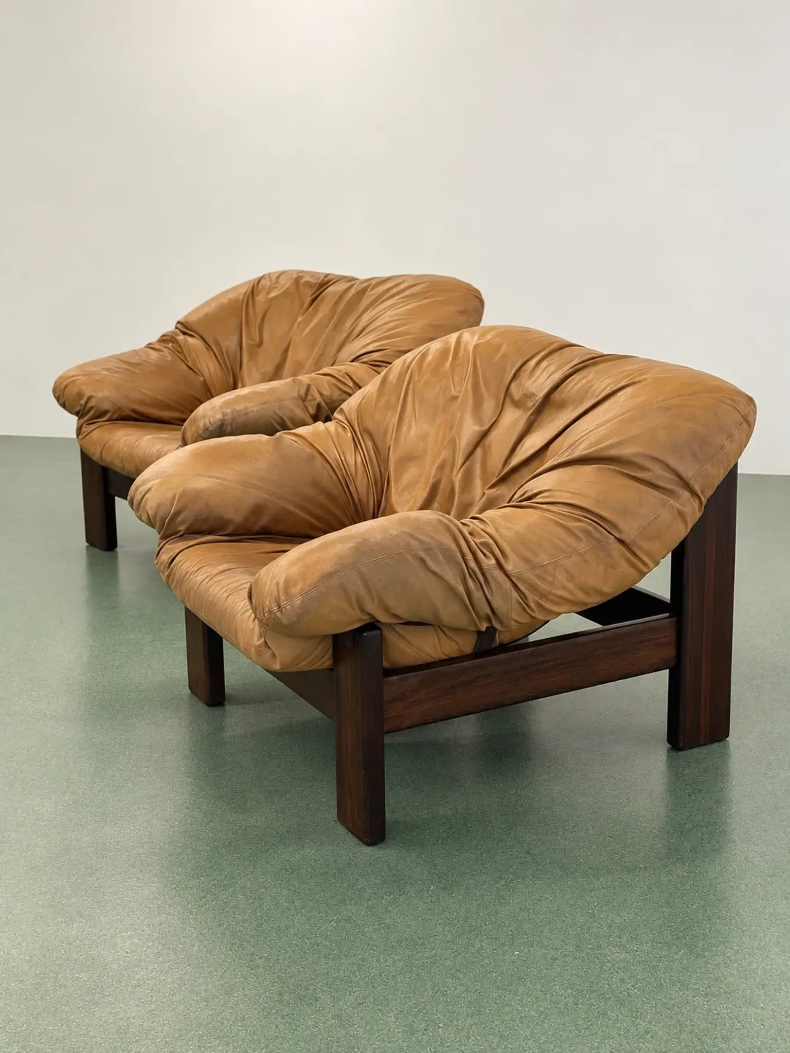 Pair of brutalist leather lounge chairs, 1960s