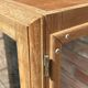 Restored antique oak display cabinet, black background, glass shelves.