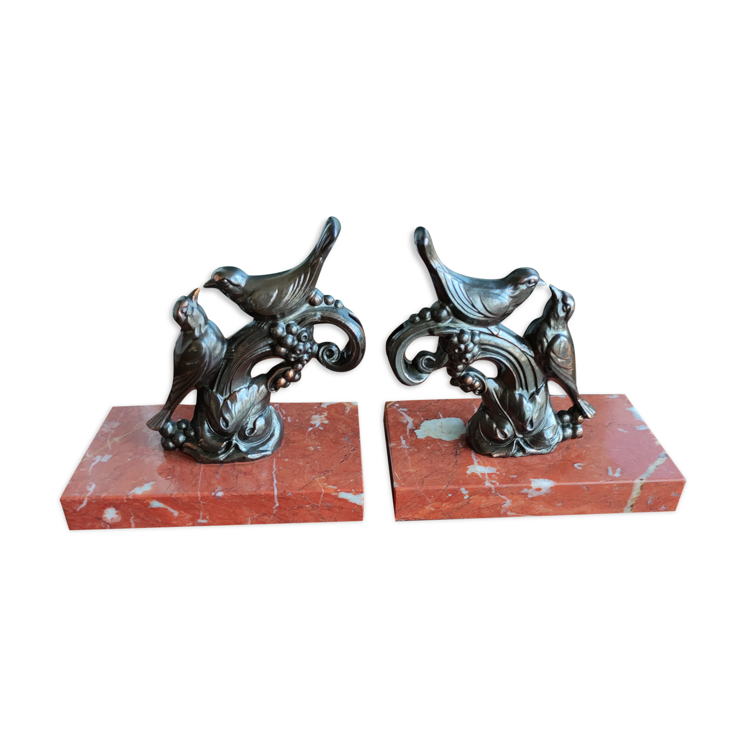 Zinc art bookends in the shape of birds on red marble - warblers