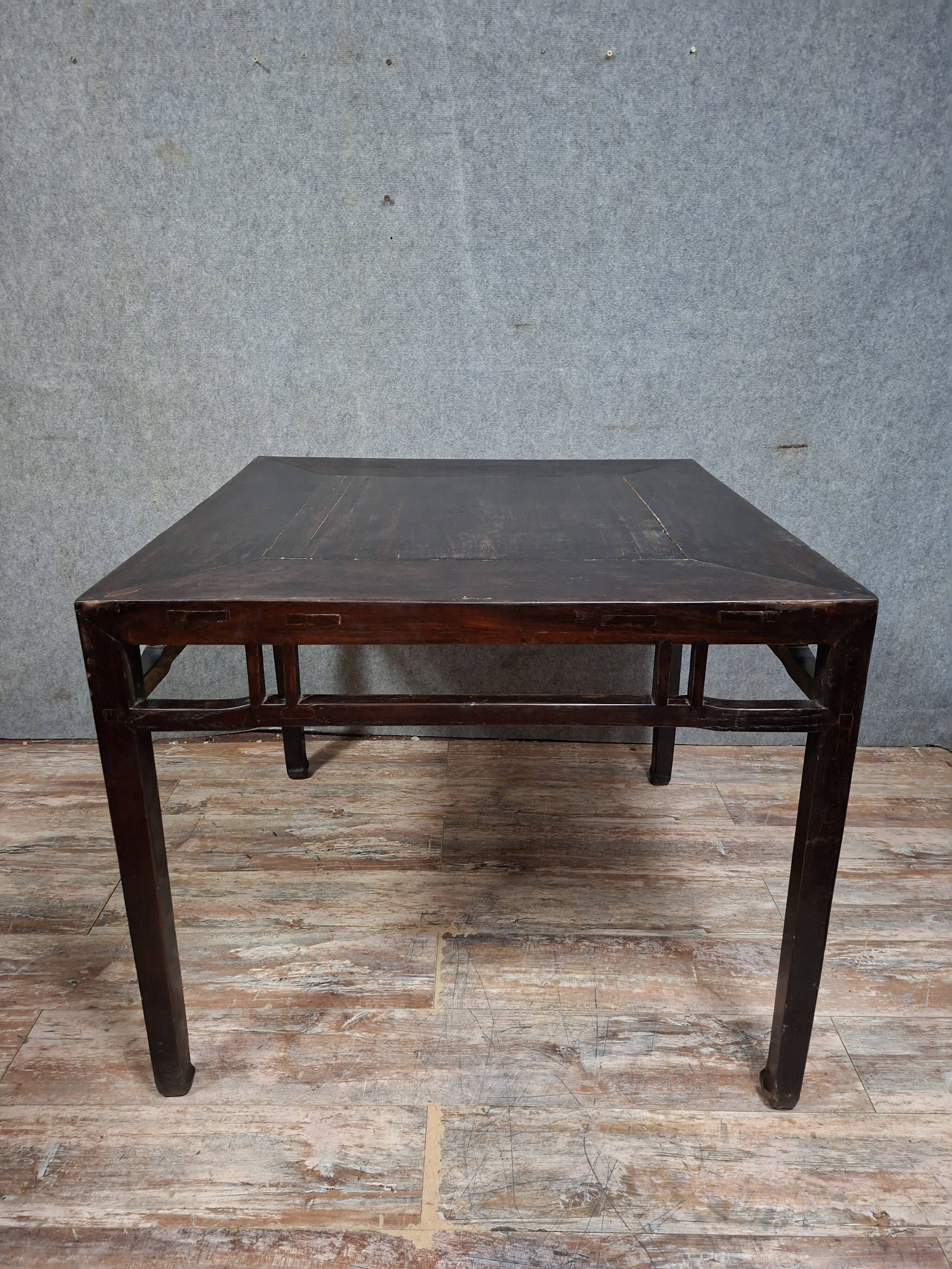 ancient Asian table, made of solid wood with a dark brown patina