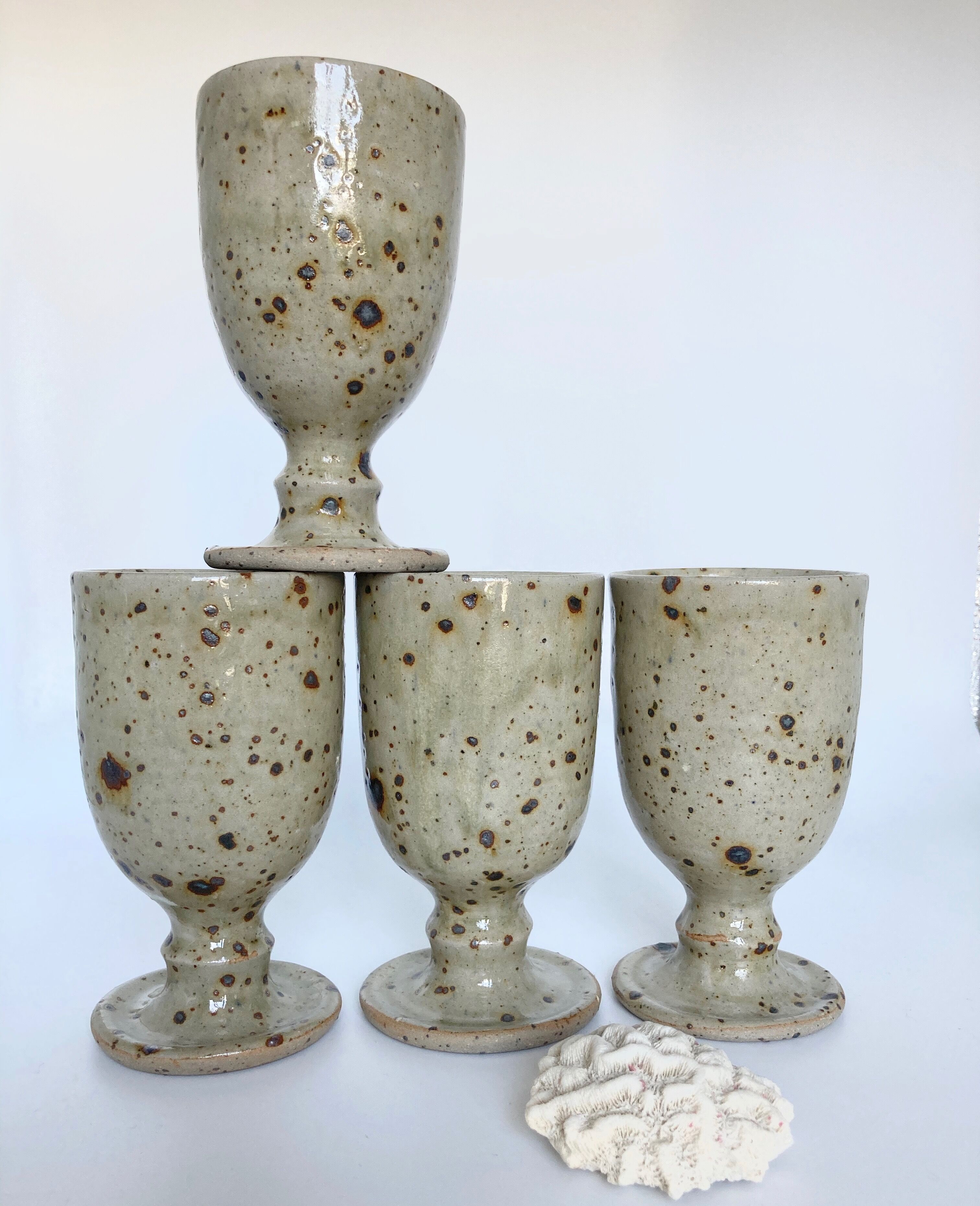Four cups made of pyrity sandstone