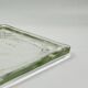 Vintage square serving tray in pale green tinted transparent glass with raised feet.