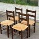 4 solid oak chairs in dark colour with elephant upholstery.