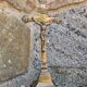 19th-century brass crucifix on a base