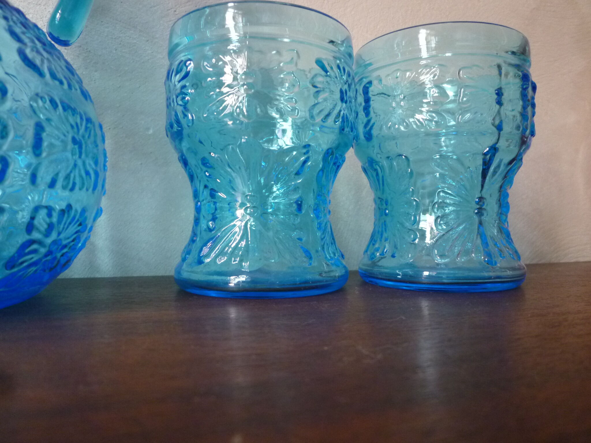 Blue glass carafe and two glasses
