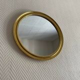 Round mirror with golden wood frame