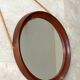 Mid Century solid teak wall mirror with a leather strap - Danish design