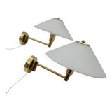 Pair of articulated arm wall lights in brass with opaline globe