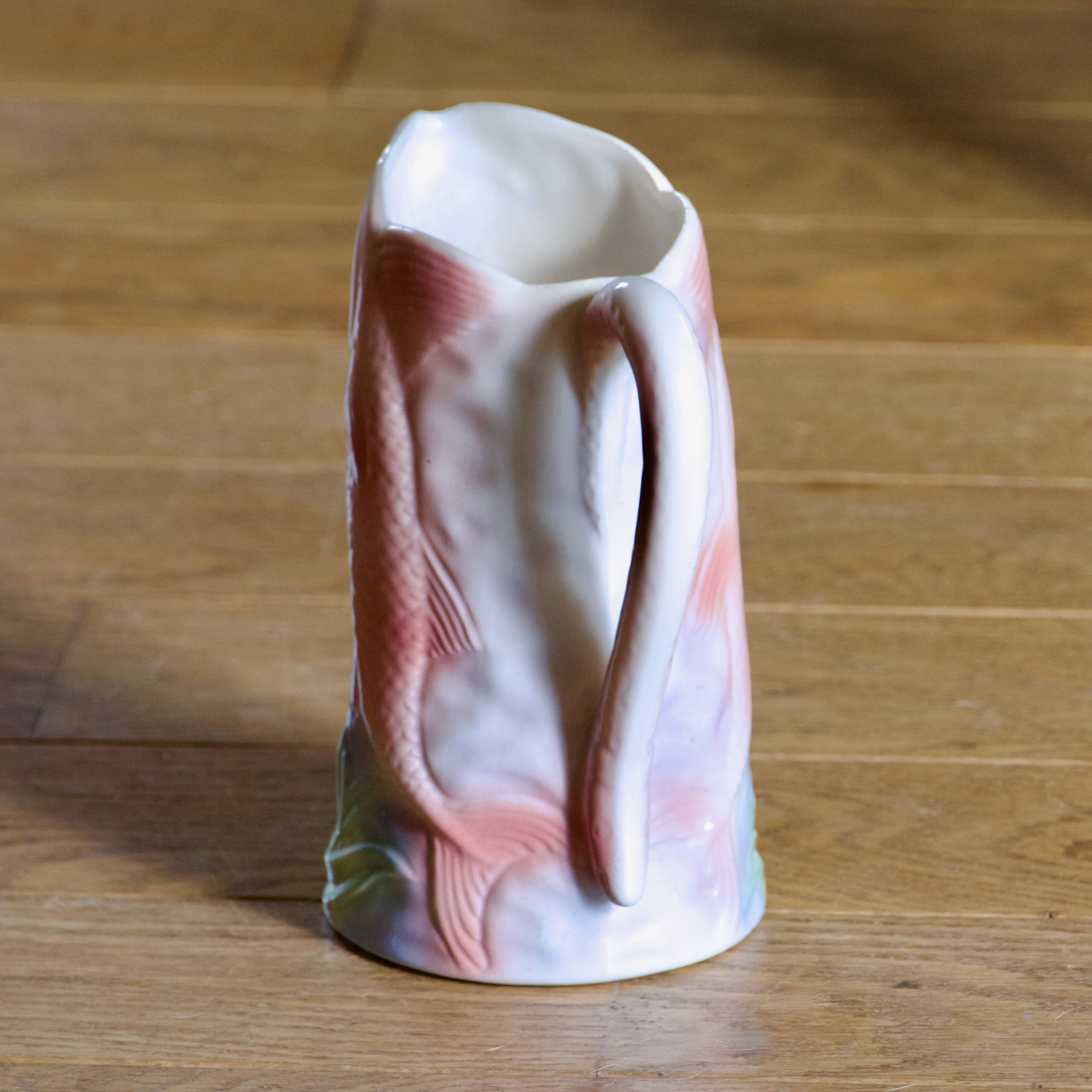 Vintage carafe in colorful fish slip