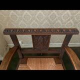 Antique armchair in carved wood with a straw seat.