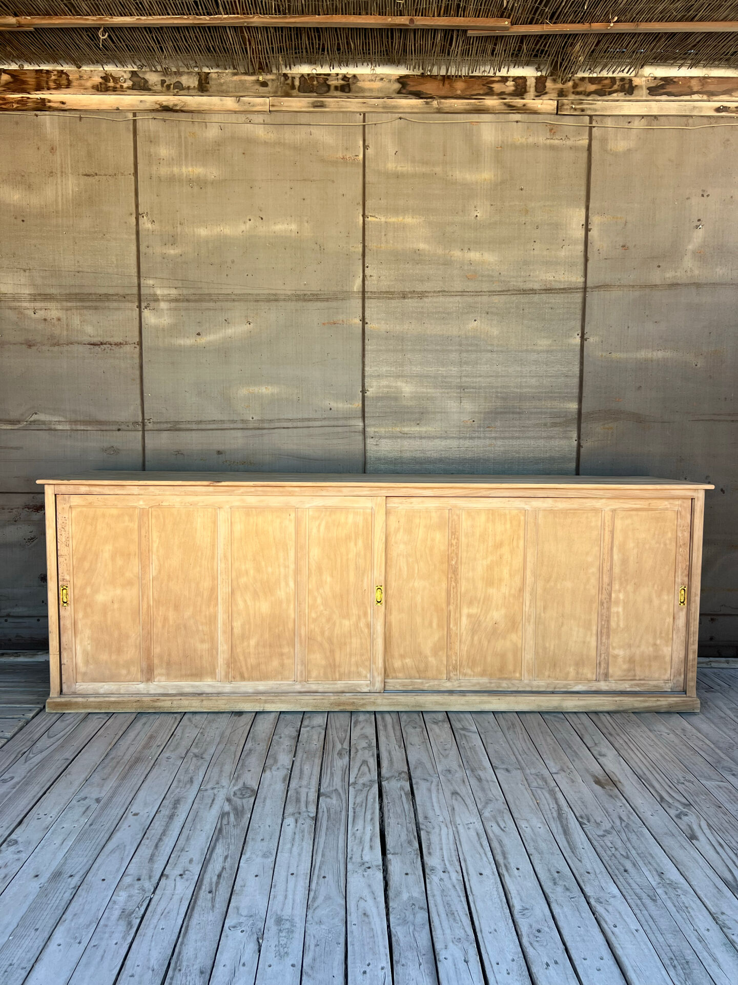 Old counter with sliding doors in raw wood