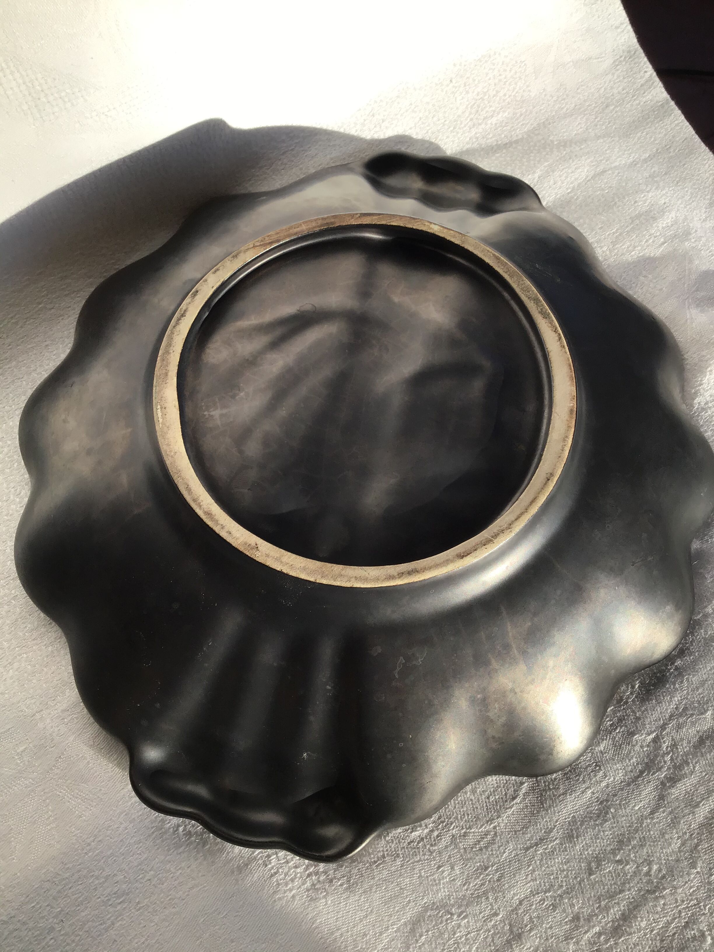 Undulating black iridescent ceramic cut