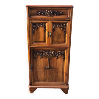 Art Deco sideboard bar cabinet in solid walnut with 3 doors and 1 richly carved tilting false drawer.