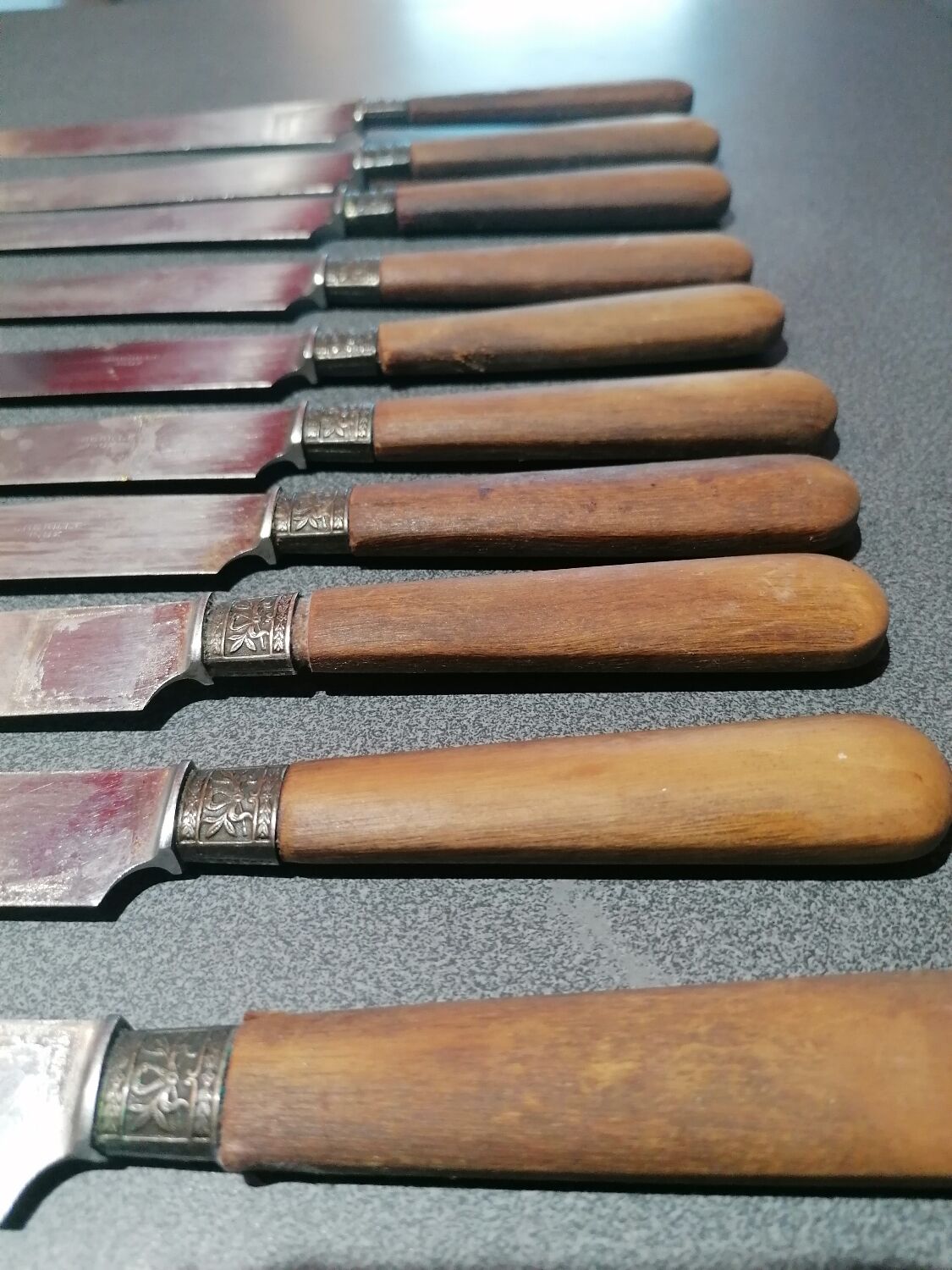 Old table knives and dessert knives, wooden handles, stainless steel blades