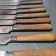 Old table knives and dessert knives, wooden handles, stainless steel blades
