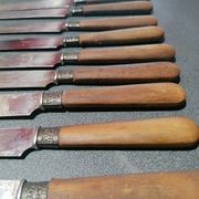 Old table knives and dessert knives, wooden handles, stainless steel blades