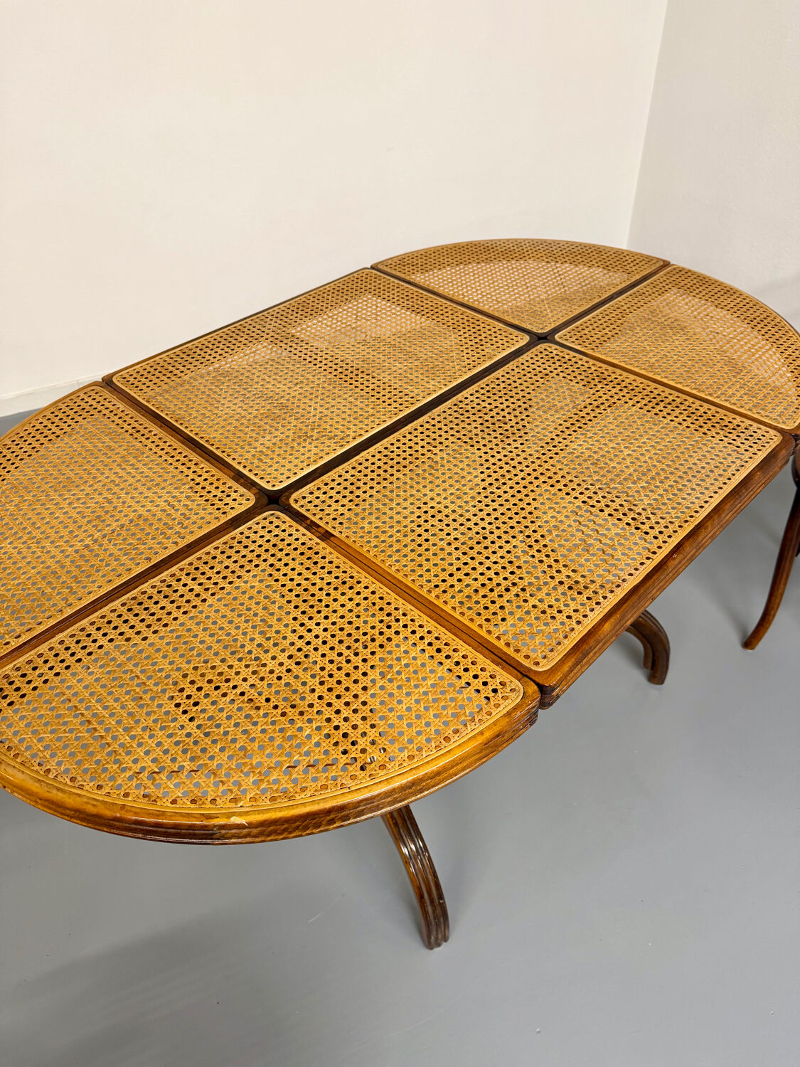 Vintage dining table with a cane top by Mundus from the 1970s.