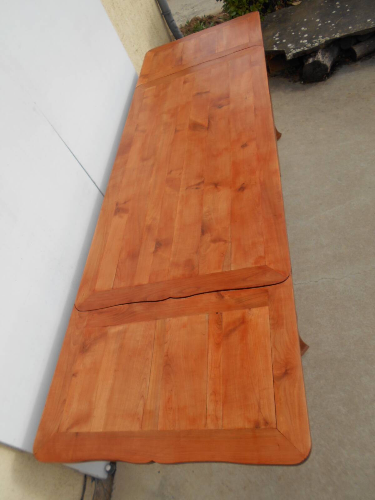 Large solid wood table with integrated extensions.