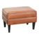 Handy sheepskin ottoman with warm colours finished with black piping