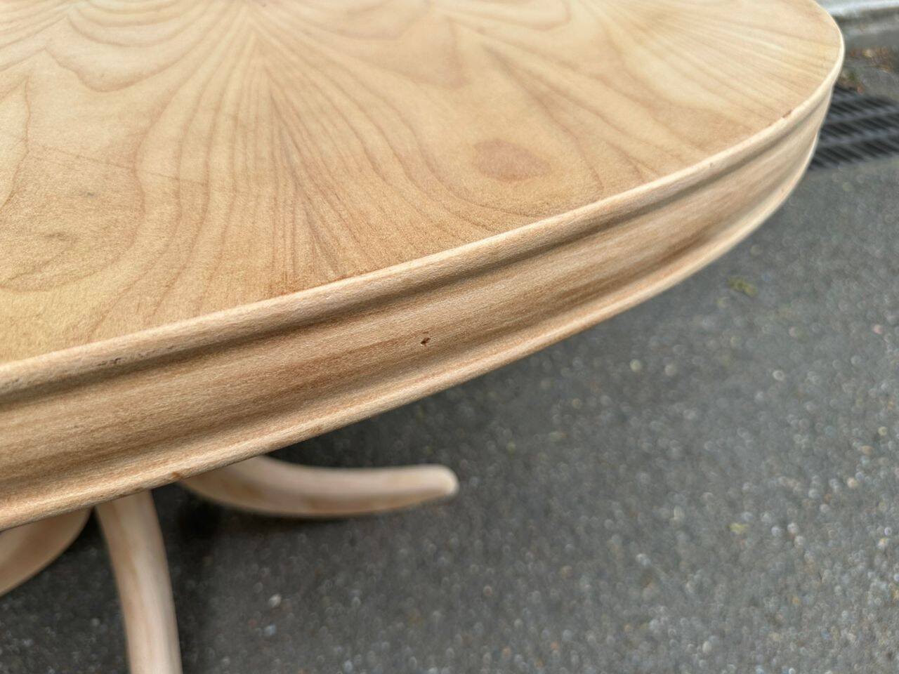 Renovated oval Scandinavian extendable dining table in wood with a central leg.