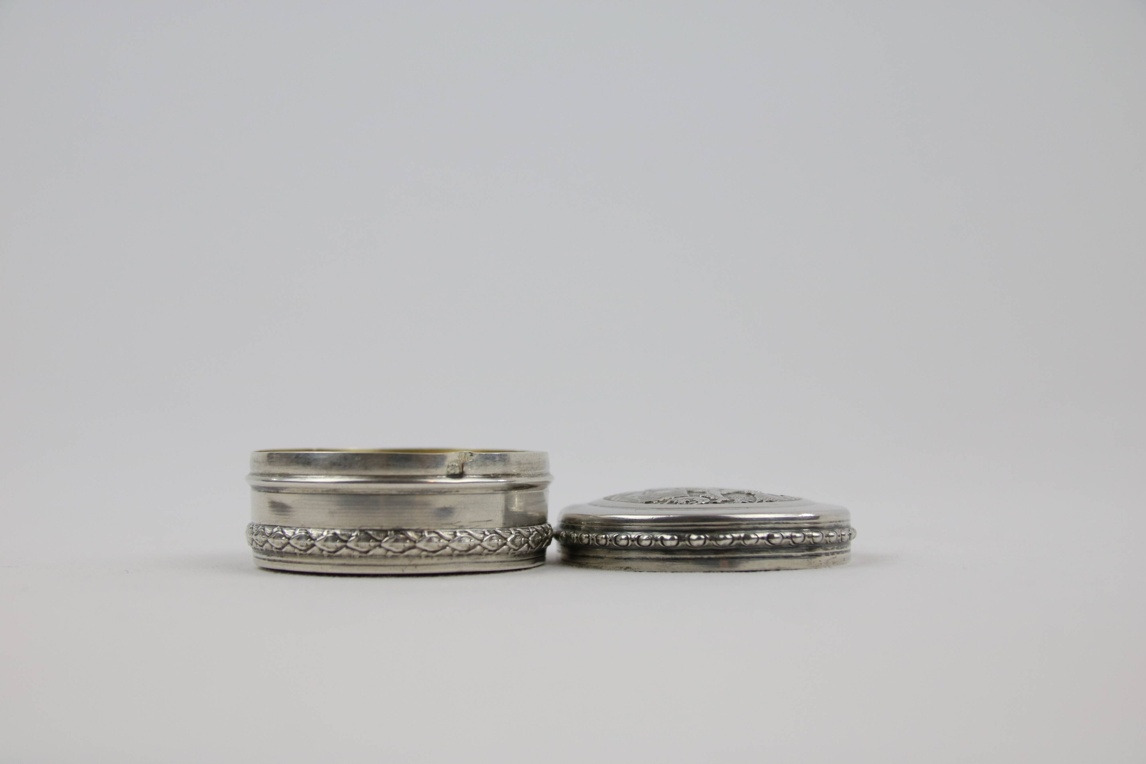 Small round box with silver pills