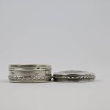Small round box with silver pills
