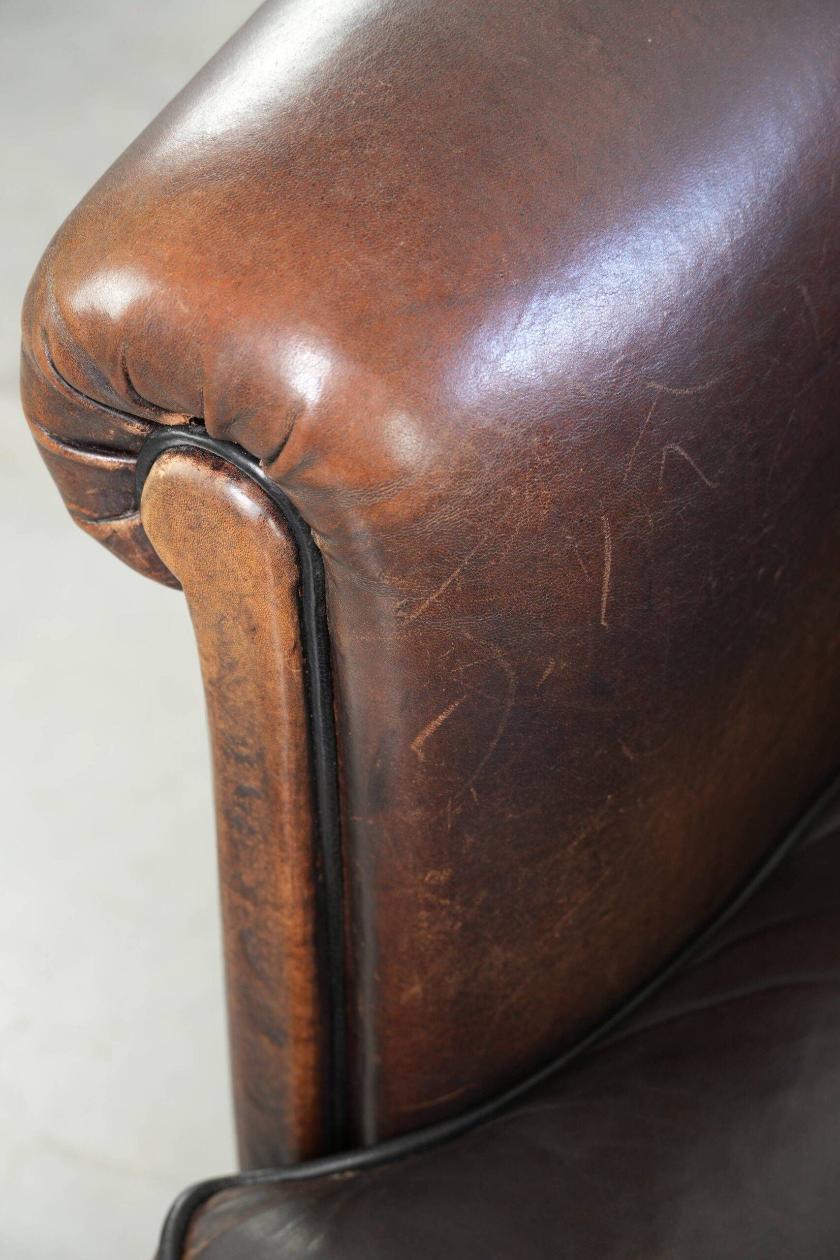 Dark sheepskin club armchair with unique design in English style