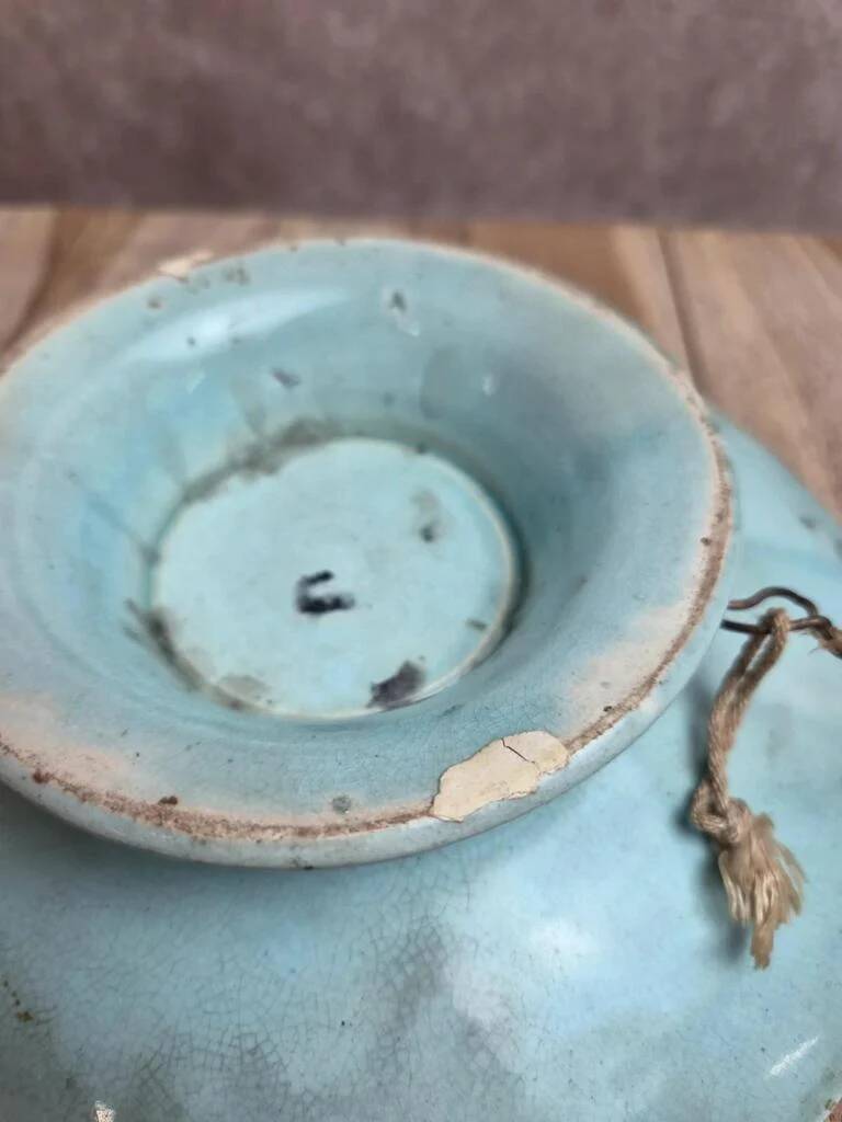 Old small compote dish in turquoise majolica with raised floral decoration.