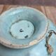 Old small compote dish in turquoise majolica with raised floral decoration.