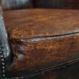 Cognac-colored vintage sheep leather wingback chair with character