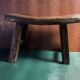 Antique milking stool in rustic curved wood, 19th century