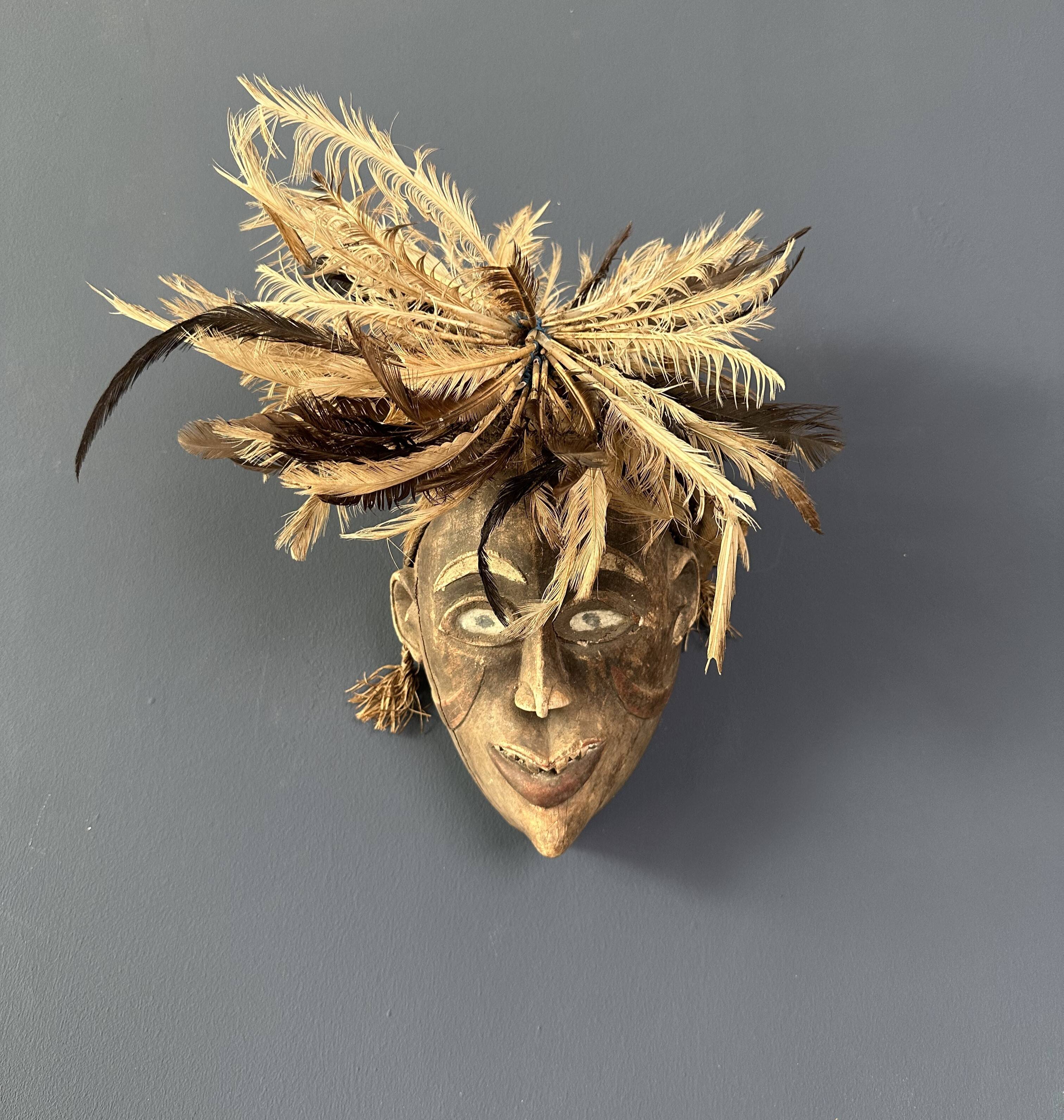 Tribal mask with feather head-decoration