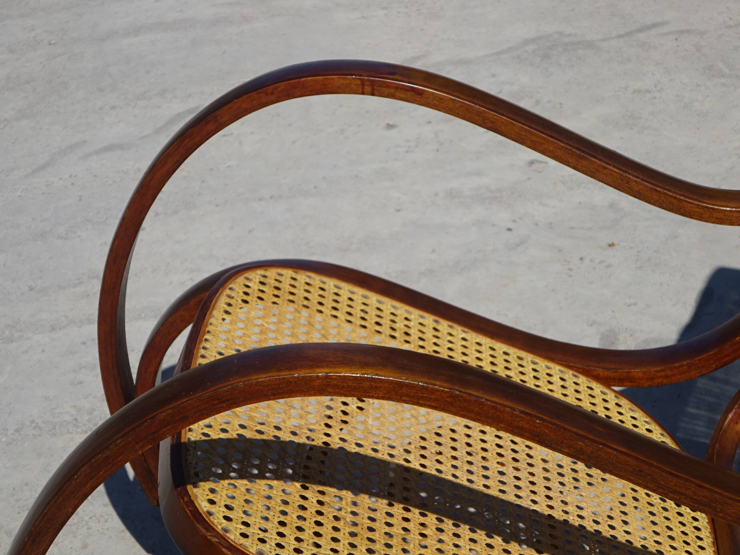 Vintage wooden rocking chair with caning