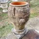 Large Cretan jar in terracotta with three handles on a stone base.