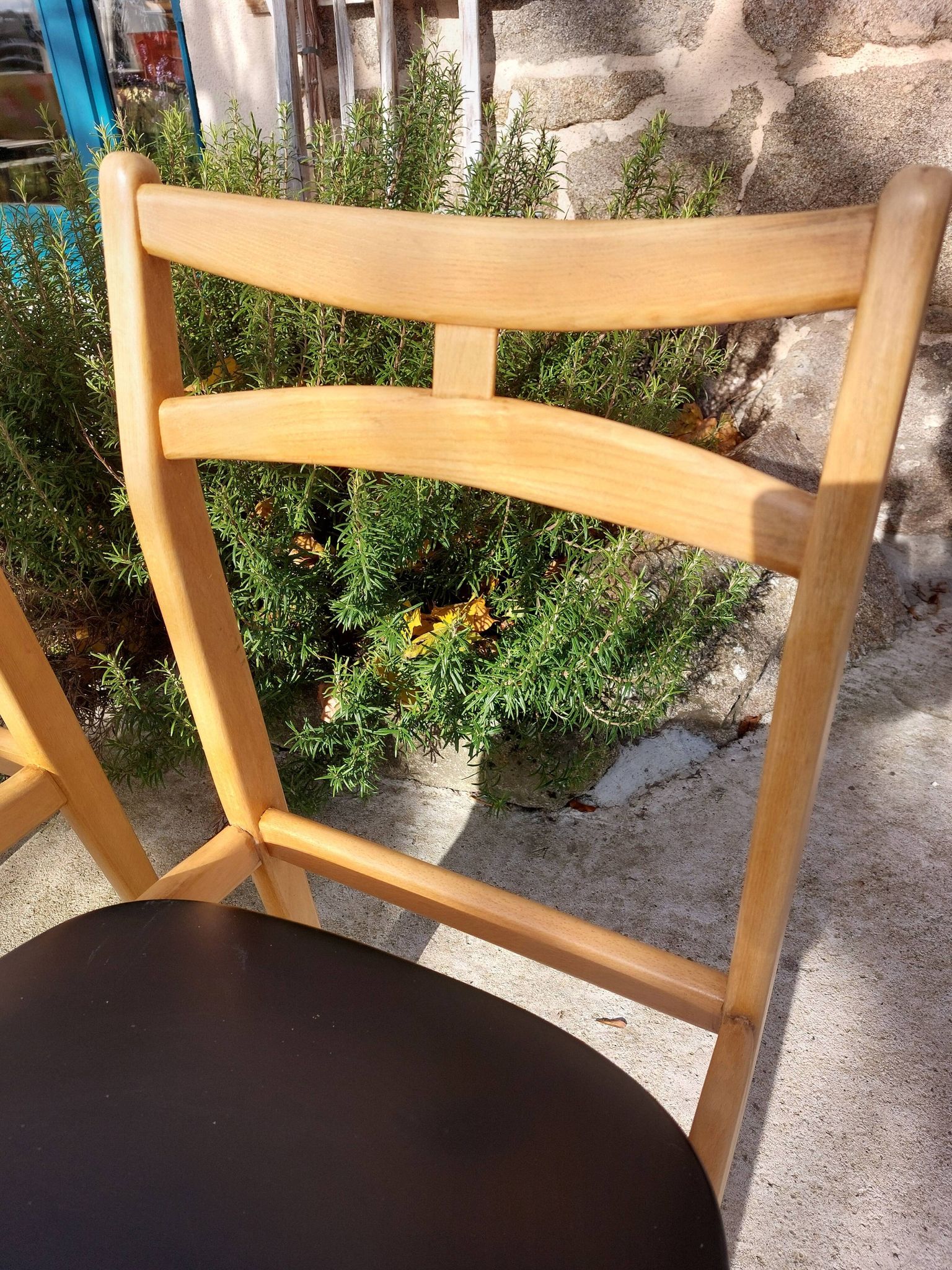 3 Scandinavian style chairs, light wood and black faux leather.
