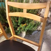 3 Scandinavian style chairs, light wood and black faux leather.
