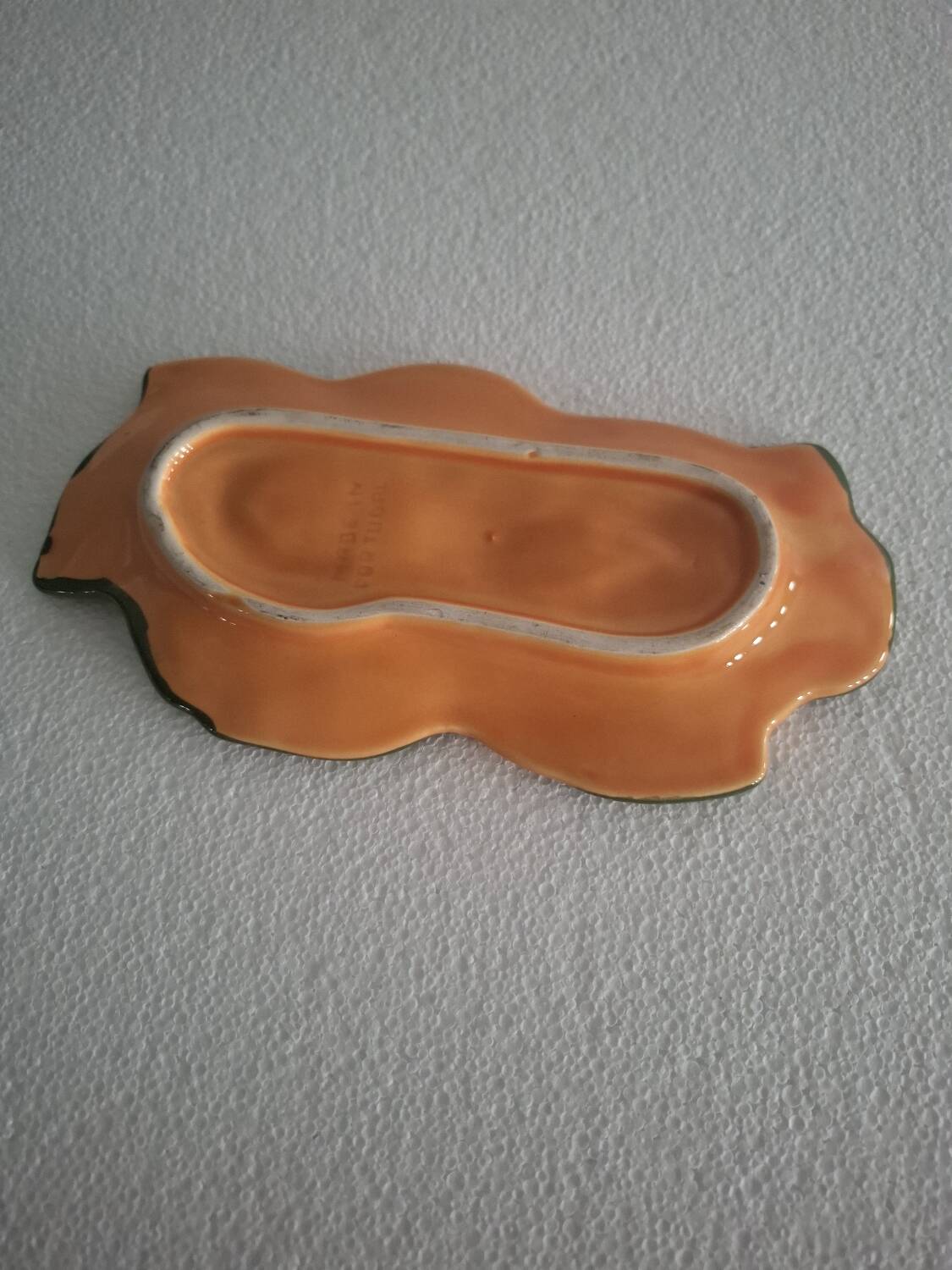 Orange trompe l'oeil slip dish.