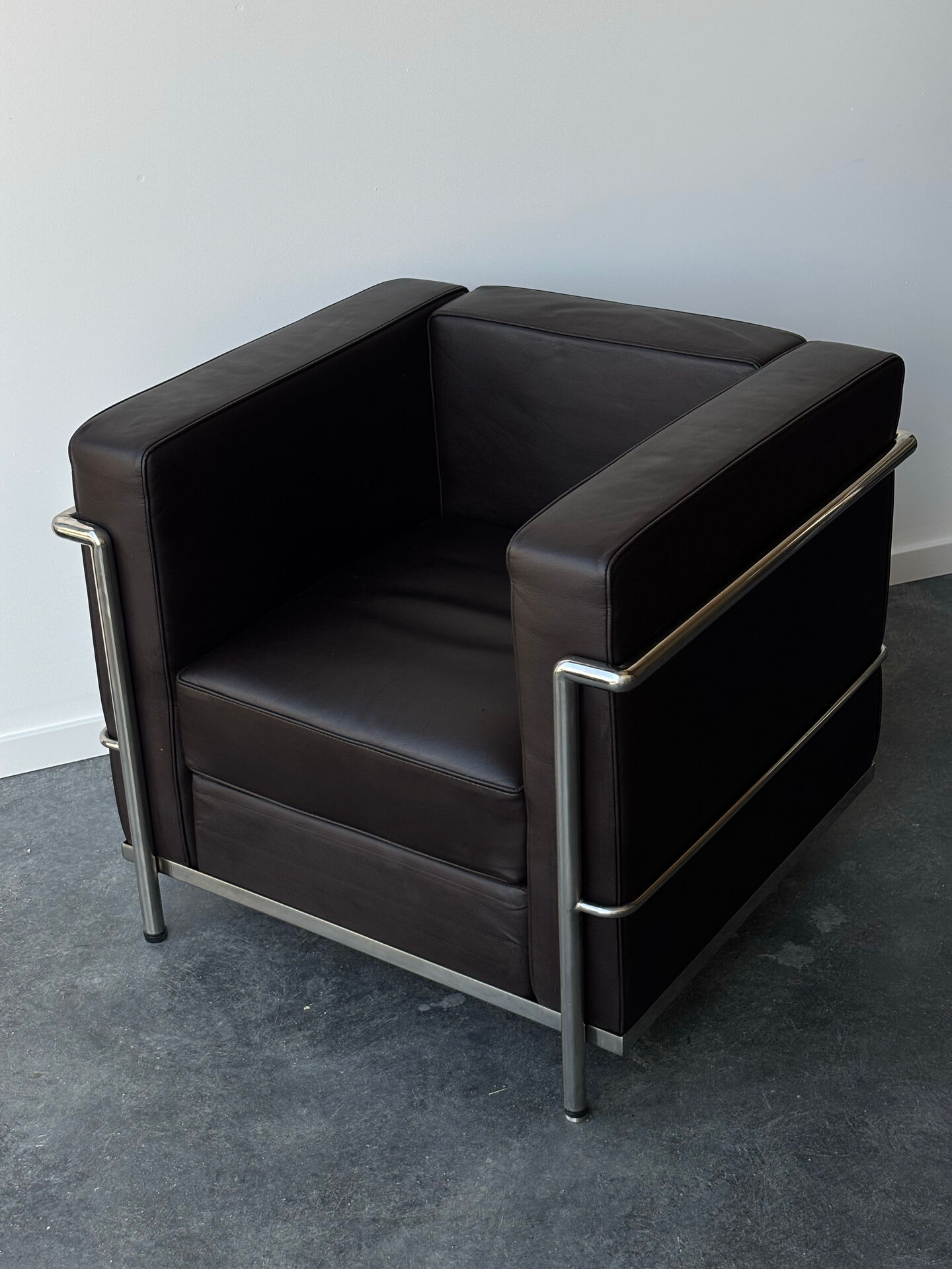 Pair of modernist brown leather armchairs
