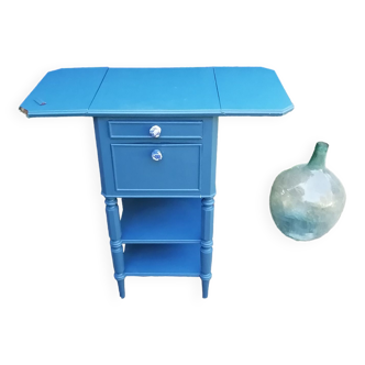 Bedside table with flaps on casters