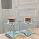 Pair of square jars in tinted glass and corks